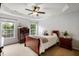 Bright bedroom with a sleigh bed, ceiling fan, and ample natural light at 5504 Skylock Dr, Raleigh, NC 27610