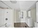 Clean bathroom with a shower/tub combo, white vanity, and a mirrored medicine cabinet at 204 W Hill St, Benson, NC 27504