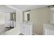 Double vanity bathroom with a large mirror and light brown wood-look flooring at 204 W Hill St, Benson, NC 27504