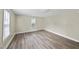 Simple bedroom with wood-look flooring and window at 204 W Hill St, Benson, NC 27504