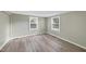 Simple bedroom with two windows, neutral walls, and light brown wood-look flooring at 204 W Hill St, Benson, NC 27504