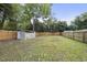 Fenced backyard with a shed and grassy area at 204 W Hill St, Benson, NC 27504