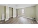 Bedroom with window, closet and wood-look floors at 204 W Hill St, Benson, NC 27504