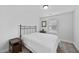 Well-lit bedroom with a full-size bed and window coverings at 151 National Dr, Clayton, NC 27527