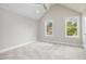 Spacious bedroom with vaulted ceilings and carpeting at 705 Jefferson St, Henderson, NC 27536