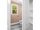 Small bathroom with a toilet, sink, and built-in shelving at 705 Jefferson St, Henderson, NC 27536