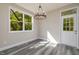 Dining area with hardwood floors and access to a backyard at 705 Jefferson St, Henderson, NC 27536