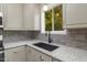 Modern kitchen sink with a black faucet and gray cabinets at 705 Jefferson St, Henderson, NC 27536