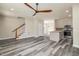 Open living space with hardwood floors and a ceiling fan at 705 Jefferson St, Henderson, NC 27536