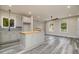 Open concept kitchen with light gray cabinets and kitchen island at 705 Jefferson St, Henderson, NC 27536