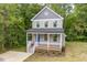 Aerial view of a two-story house with a yard at 705 Jefferson St, Henderson, NC 27536