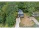 Aerial view of a charming two-story house with a driveway, nestled among lush green trees at 705 Jefferson St, Henderson, NC 27536