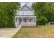 Two-story craftsman style home with gray siding, white trim, and a front porch at 705 Jefferson St, Henderson, NC 27536