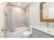 Bathroom with bathtub, tiled walls, and granite vanity at 705 Jefferson St, Henderson, NC 27536