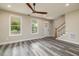 Living room with hardwood floors and a view of the staircase at 705 Jefferson St, Henderson, NC 27536