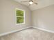 Well-lit bedroom featuring carpeted floors and a window at 705 Jefferson St, Henderson, NC 27536