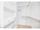 Bright walk-in closet with built in shelves and rods at 705 Jefferson St, Henderson, NC 27536