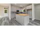 Kitchen island with butcher block countertop and gray cabinets at 705 Jefferson St, Henderson, NC 27536
