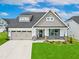 Two-story home with a gray exterior and teal door at 1055 Fairhaven Dr # 56, Mebane, NC 27302