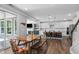 Open concept dining area with wooden table and chairs, overlooking the kitchen and living room at 233 Golf Vista Trl, Holly Springs, NC 27540