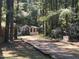 Mobile home on wooded lot with gravel driveway at 1150 Old County Home Rd, Nashville, NC 27856
