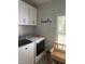 Laundry room with washer, dryer, and built-in cabinets at 1150 Old County Home Rd, Nashville, NC 27856