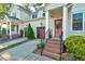 Close up view of two story tan home exterior with attached garage and front porch at 532 Lena Cir, Chapel Hill, NC 27516