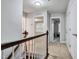 Upstairs hallway with carpet and doors to bedrooms at 532 Lena Cir, Chapel Hill, NC 27516