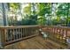Wooden deck overlooking a wooded backyard with partial view of a fenced-in pool at 532 Lena Cir, Chapel Hill, NC 27516