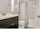 Clean bathroom with dark vanity, shower/tub combo, and teal accents at 532 Lena Cir, Chapel Hill, NC 27516