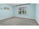 Light blue bedroom with gray carpeting, featuring a window with blinds and a floating shelf at 532 Lena Cir, Chapel Hill, NC 27516