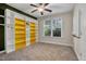 Bright bedroom with built-in shelving and ceiling fan at 532 Lena Cir, Chapel Hill, NC 27516