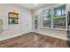 Kitchen with hardwood floors, access to backyard, and white cabinets at 532 Lena Cir, Chapel Hill, NC 27516