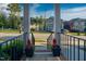 Front porch view with black railing, brick steps and flower pots at 532 Lena Cir, Chapel Hill, NC 27516