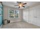 Bedroom with ceiling fan, window, and double doors at 532 Lena Cir, Chapel Hill, NC 27516