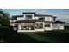 Back exterior view of a modern home with a large deck at 2209 Paddstowe Main Way, Wake Forest, NC 27587