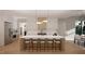 Modern kitchen with large island and contemporary lighting at 2209 Paddstowe Main Way, Wake Forest, NC 27587