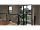 Modern staircase with metal railing and large windows at 2209 Paddstowe Main Way, Wake Forest, NC 27587