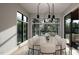 Bright dining room features a large table with seating for eight and modern light fixtures at 2209 Paddstowe Main Way, Wake Forest, NC 27587