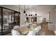 Open concept dining room with kitchen view, seating for eight, and access to a patio at 2209 Paddstowe Main Way, Wake Forest, NC 27587