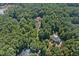 Two homes nestled in a wooded area with a pond at 6300 Swallow Cove Ln, Raleigh, NC 27614