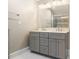 Double vanity bathroom with gray cabinets and quartz countertop at 6300 Swallow Cove Ln, Raleigh, NC 27614