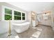 Luxurious bathroom with a freestanding soaking tub and double vanity at 6300 Swallow Cove Ln, Raleigh, NC 27614