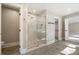 Spa-like bathroom with a frameless glass shower and marble tile at 6300 Swallow Cove Ln, Raleigh, NC 27614