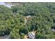 Aerial view of house, pool, and surrounding woods at 6300 Swallow Cove Ln, Raleigh, NC 27614