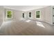 Spacious bedroom with carpet flooring, multiple windows, and private balcony access at 6300 Swallow Cove Ln, Raleigh, NC 27614