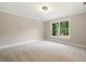 Well-lit bedroom with carpet flooring and a window at 6300 Swallow Cove Ln, Raleigh, NC 27614