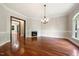 Spacious dining room featuring hardwood floors, fireplace, and access to other rooms at 6300 Swallow Cove Ln, Raleigh, NC 27614