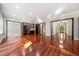 Open living room with hardwood floors and built-in wine storage at 6300 Swallow Cove Ln, Raleigh, NC 27614