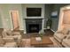 Living room with fireplace, comfortable seating, and decorative accents at 108 Cullen Ct, Clayton, NC 27520